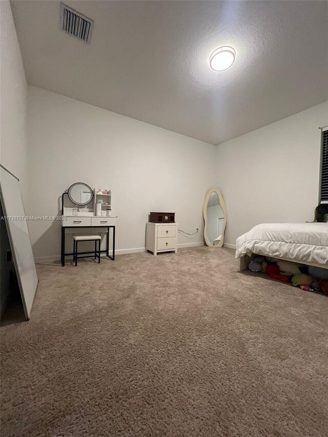 bedroom with carpet flooring and a textured ceiling