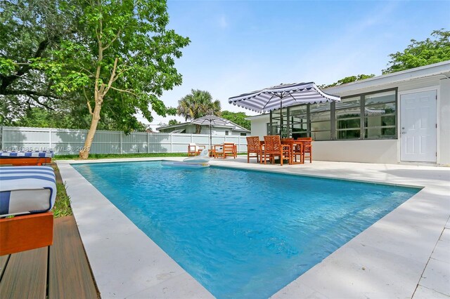 view of swimming pool featuring a patio area