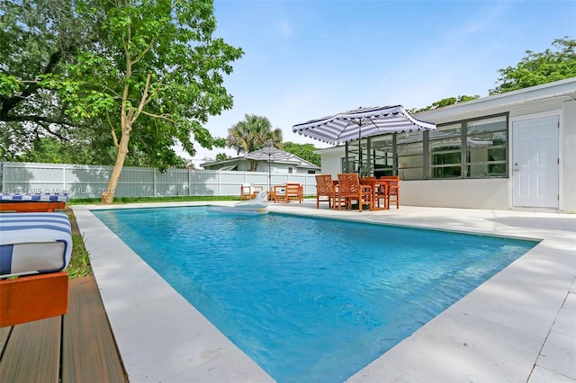 view of swimming pool with a patio area