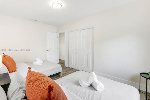 bedroom featuring hardwood / wood-style flooring and a closet