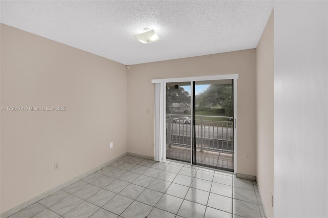 2050 NE 140th St Unit 1, North Miami Beach, FL 33181 - spare room with a textured ceiling, light tile patterned floors, and baseboards