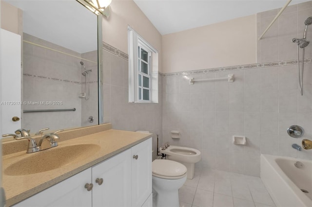 full bathroom featuring vanity, a bidet, tile walls, and tile patterned floors