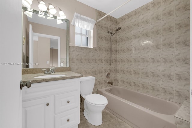 full bathroom with vanity, tiled shower / bath, tile patterned flooring, and toilet