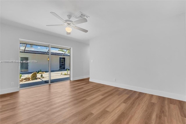 empty room with ceiling fan and light hardwood / wood-style floors