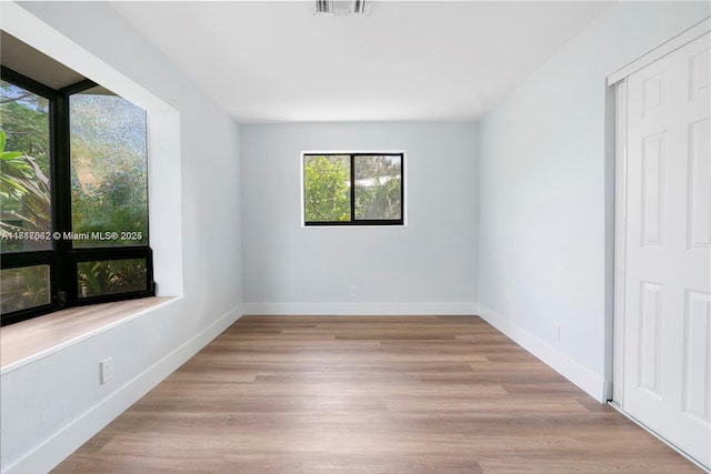 spare room featuring light hardwood / wood-style floors