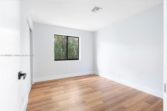 empty room with light hardwood / wood-style floors