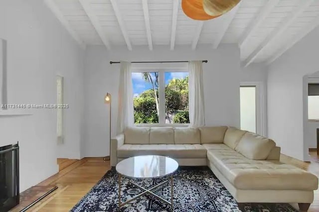 living room with beam ceiling and light hardwood / wood-style floors