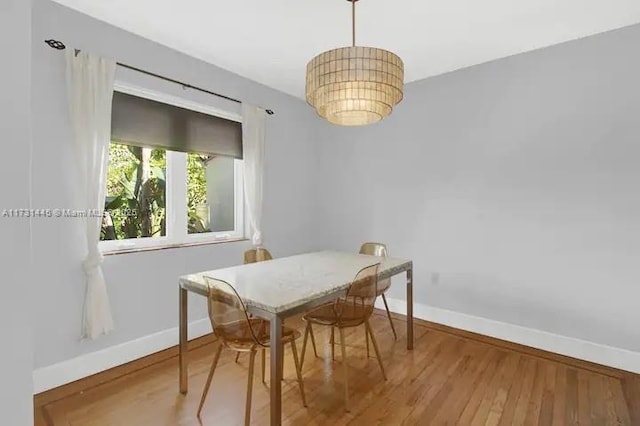 dining space with hardwood / wood-style flooring