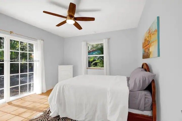 bedroom with ceiling fan and multiple windows