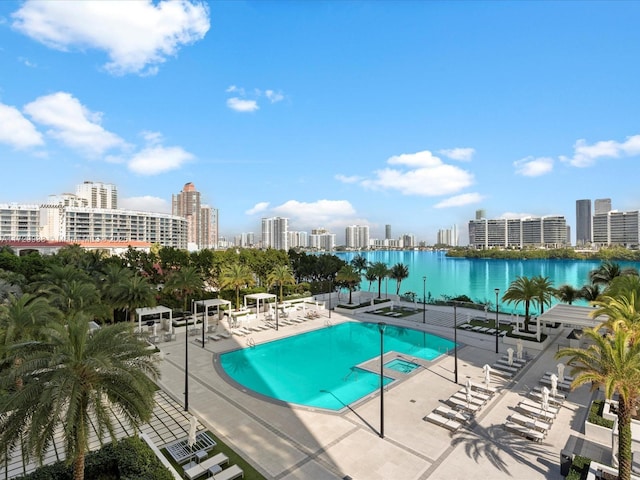 view of pool with a water view and a patio area