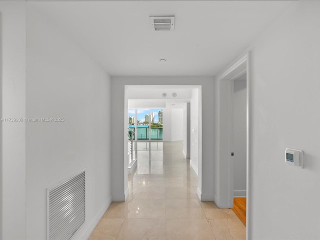 hall featuring light tile patterned flooring