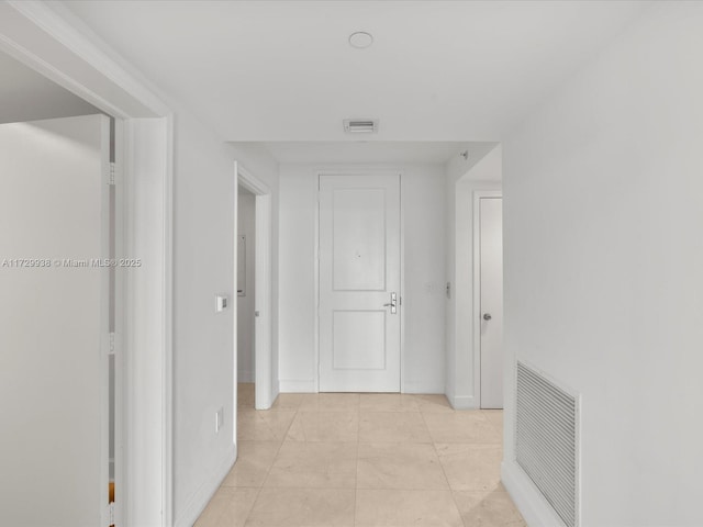 corridor featuring light tile patterned floors