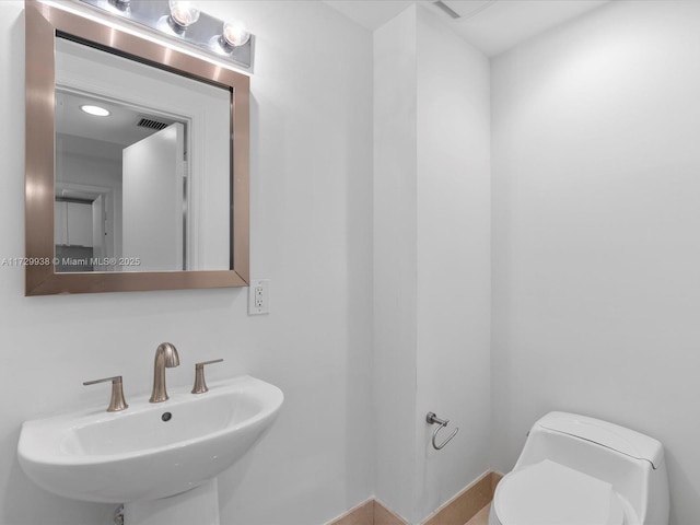 bathroom with toilet and sink