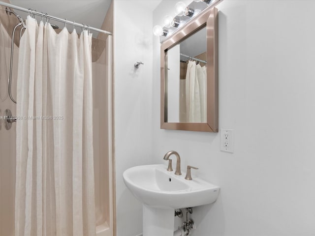 bathroom with sink and a shower with shower curtain