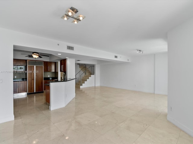 interior space featuring ceiling fan and sink