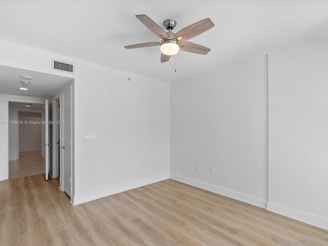 spare room featuring ceiling fan and light hardwood / wood-style floors