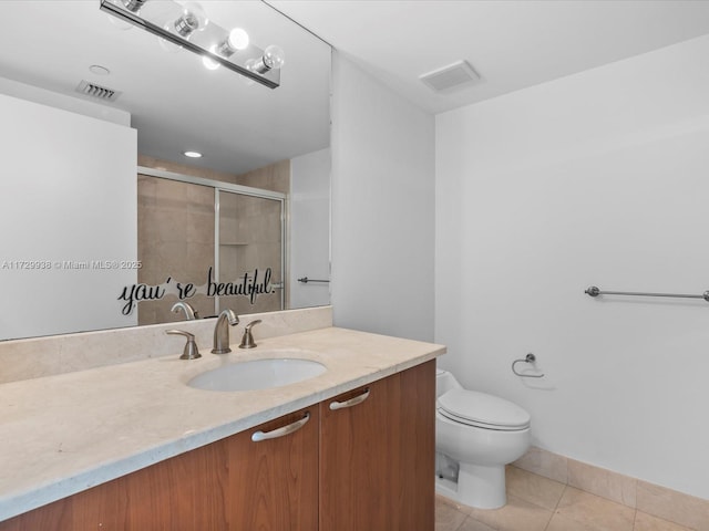 bathroom with vanity, a shower with shower door, tile patterned floors, and toilet