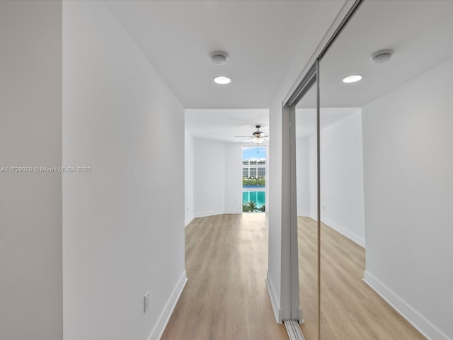 hallway with light hardwood / wood-style flooring