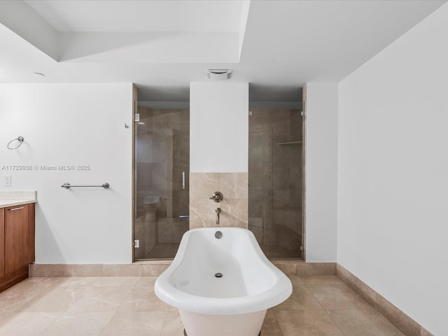 bathroom with tile patterned flooring, vanity, and separate shower and tub