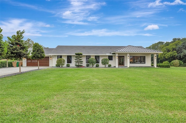 single story home with a garage and a front lawn