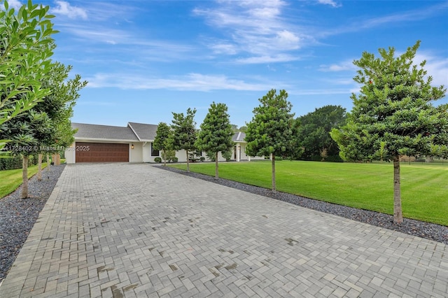 ranch-style home featuring a garage and a front yard