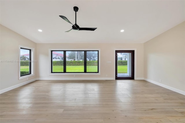 spare room with vaulted ceiling, ceiling fan, and light hardwood / wood-style floors