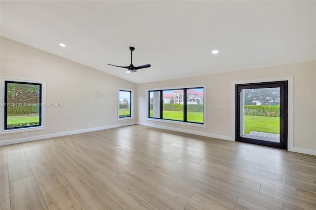 unfurnished room with vaulted ceiling, ceiling fan, and light hardwood / wood-style flooring