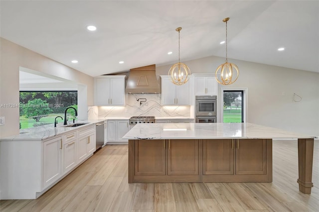 kitchen featuring a large island, sink, white cabinets, and premium range hood