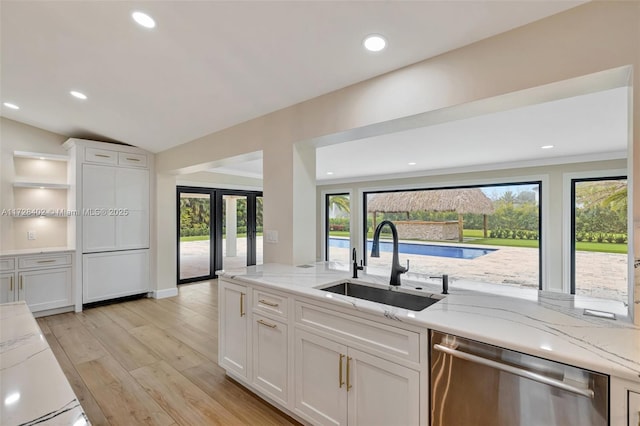 kitchen with dishwasher, sink, and white cabinets