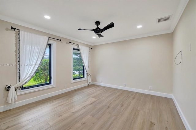 spare room featuring crown molding, ceiling fan, and light wood-type flooring