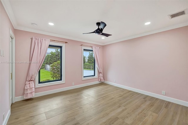 spare room featuring ornamental molding, ceiling fan, and light wood-type flooring