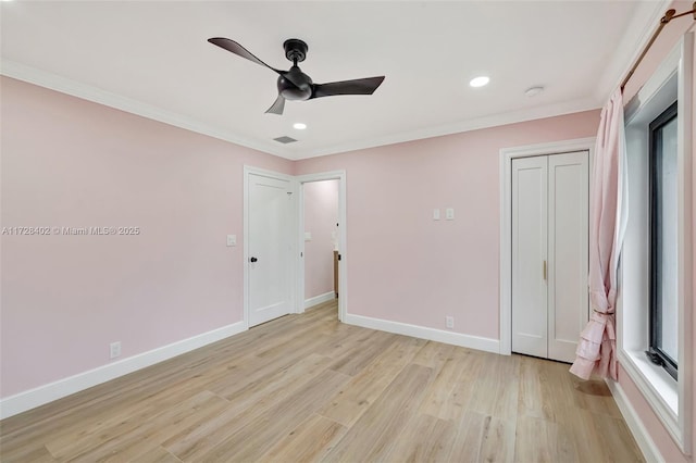 unfurnished bedroom featuring a closet, crown molding, ceiling fan, and light hardwood / wood-style floors