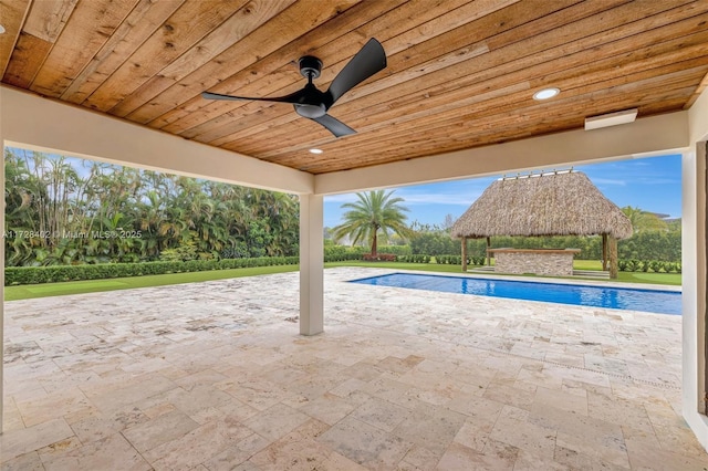 view of swimming pool with a gazebo, ceiling fan, and a patio