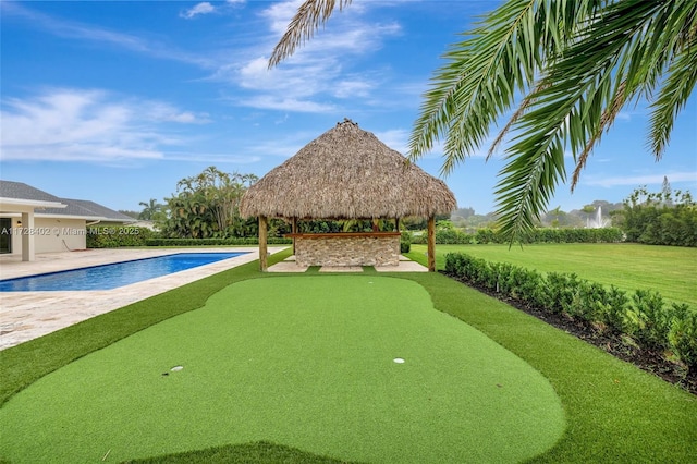 view of swimming pool with a gazebo and a lawn