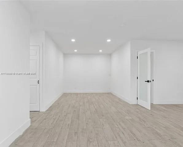 unfurnished room with light hardwood / wood-style flooring