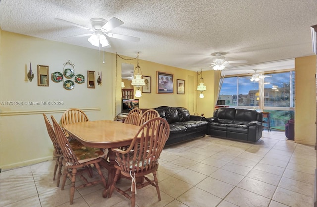 tiled dining room with a textured ceiling and ceiling fan