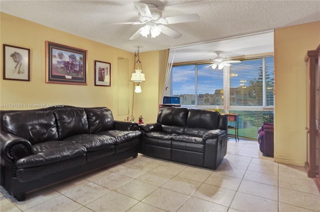 tiled living room with ceiling fan and a textured ceiling