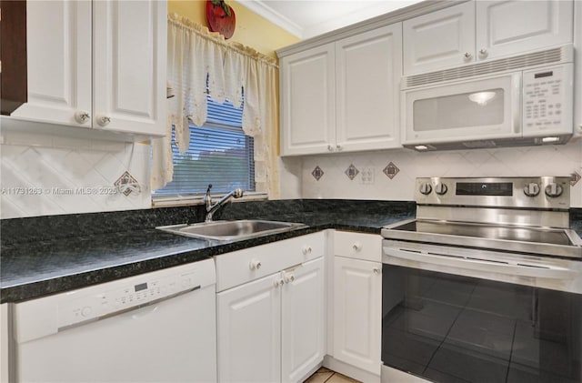 kitchen with tasteful backsplash, sink, white appliances, and white cabinets