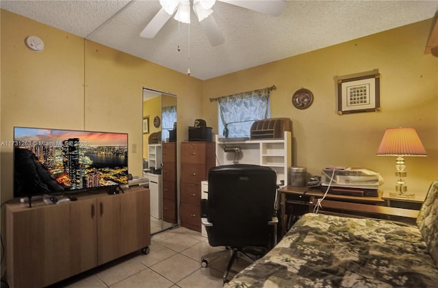 tiled home office featuring ceiling fan and a textured ceiling