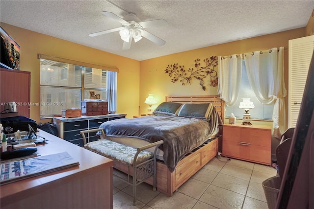 tiled bedroom featuring ceiling fan and a textured ceiling