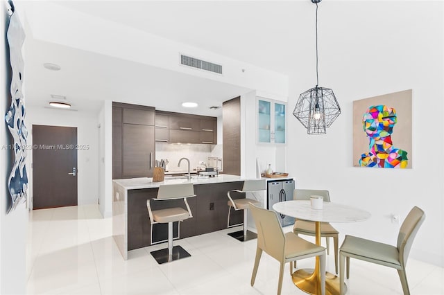 dining space with sink and light tile patterned floors