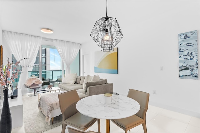 tiled dining space featuring an inviting chandelier