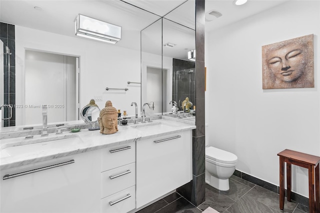 bathroom featuring tile patterned floors, vanity, toilet, and an enclosed shower