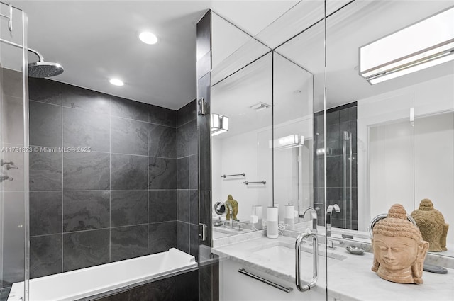 bathroom featuring vanity and tiled shower / bath