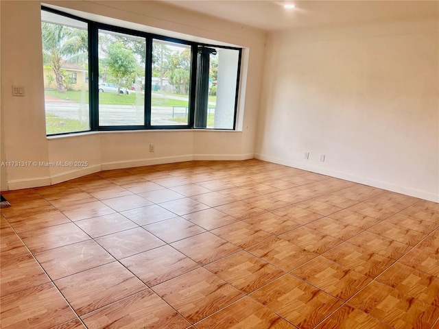 tiled empty room featuring a healthy amount of sunlight