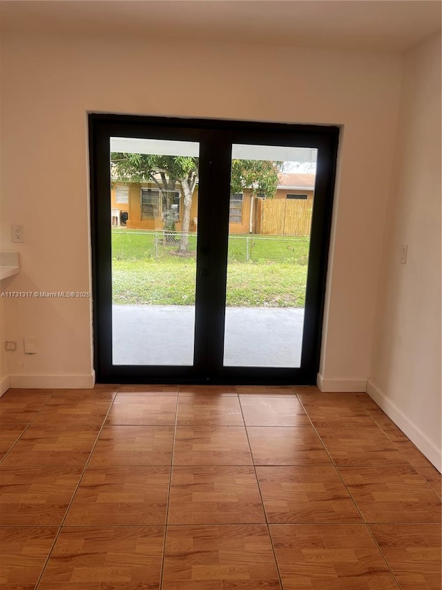 entryway featuring french doors, tile patterned floors, and a wealth of natural light