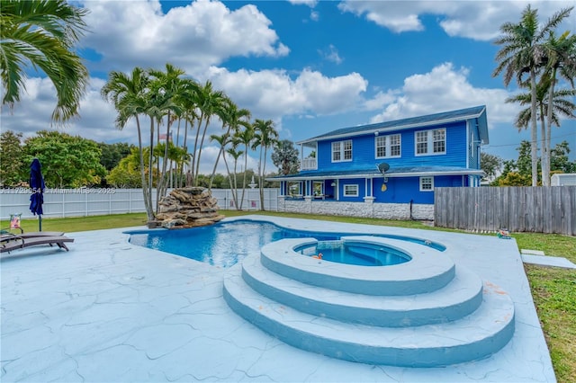 view of swimming pool with a patio and an in ground hot tub