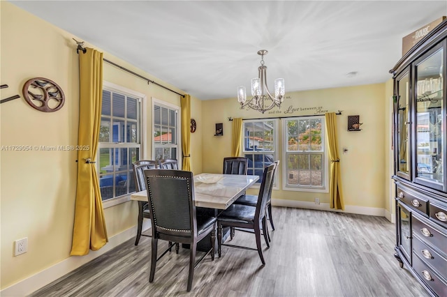 dining space with an inviting chandelier and light wood-type flooring