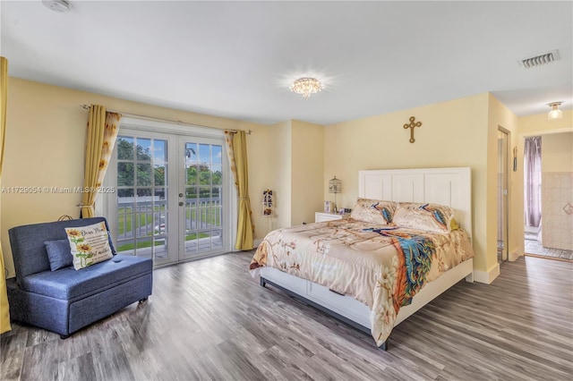 bedroom with access to exterior, wood-type flooring, and french doors