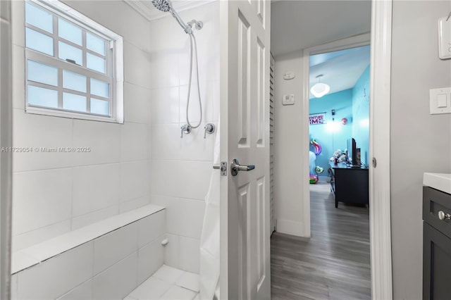 bathroom with walk in shower, vanity, and wood-type flooring